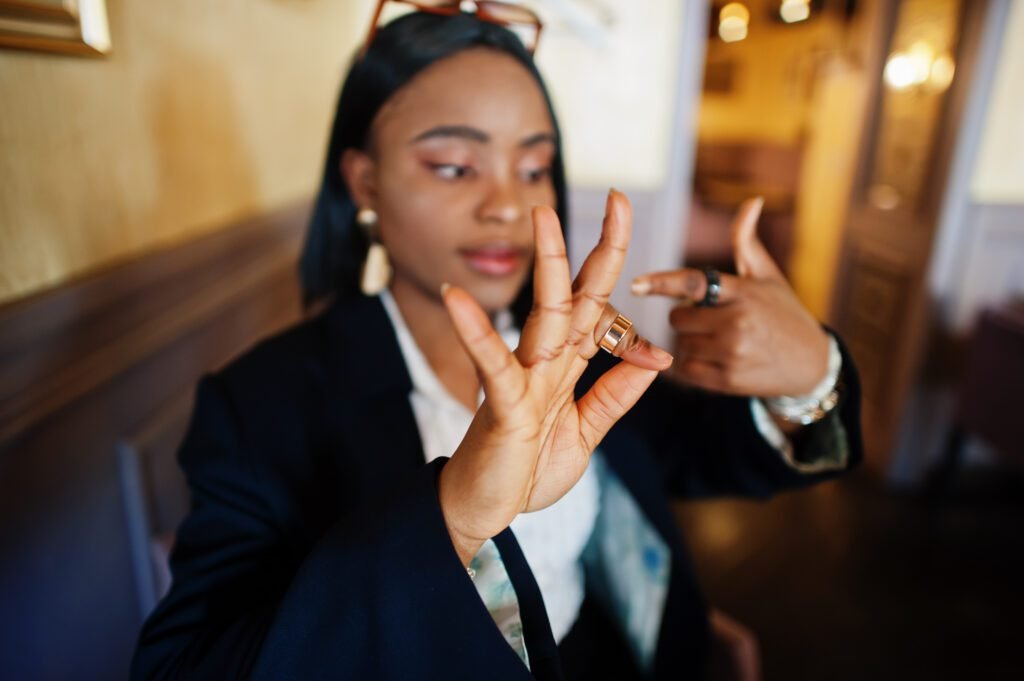 Young deaf mute African American woman using sign language.