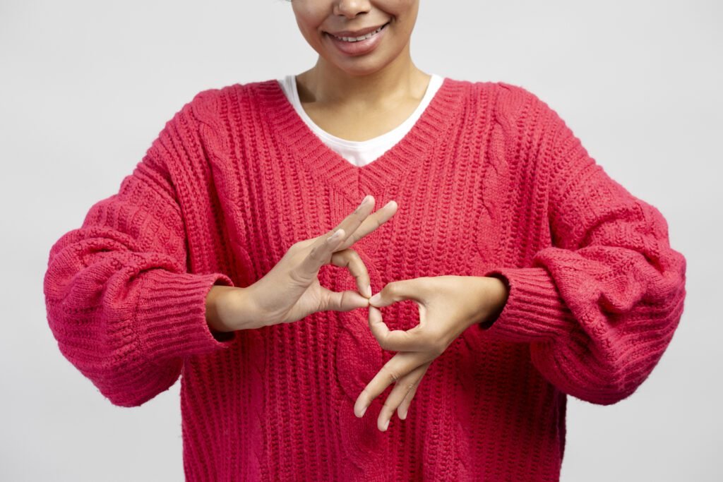 Lady Wearing A Pink Sweater Interpreting